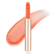 Mossicare Hydrating Lip Plumper Balm – Peach shimmery lip balm stick in a gold tube labeled 'JUICY DRIP SHIMMERY LIPS' with a large diagonal peach shimmer swatch on a white background.