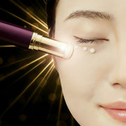 Mossicare Eye Cream Stick - Anti-Wrinkle & Firming – close-up of a woman's closed eye with cream dots, purple and gold balm stick tip near under-eye area with golden light rays