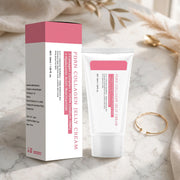 Mossicare Collagen Jelly Cream – A white tube and matching box of PDRN Collagen Jelly Cream with pink accents, styled on a marble surface with soft fabric and dried grass props.
