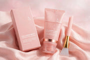Mossicare Collagen Night Wrapping Mask – pink squeeze tube with rose gold band and water droplets, matching pink product box, and pink silicone applicator with gold handle, arranged on draped pink satin fabric